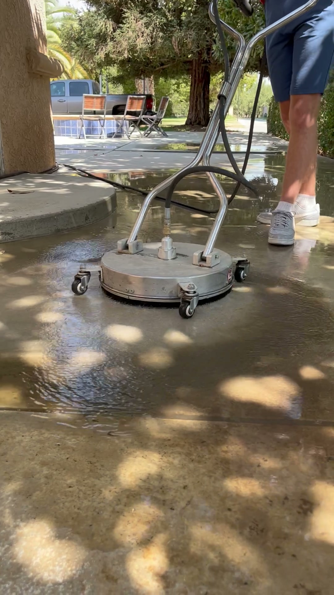 Surface cleaner in use on a residential concrete patio